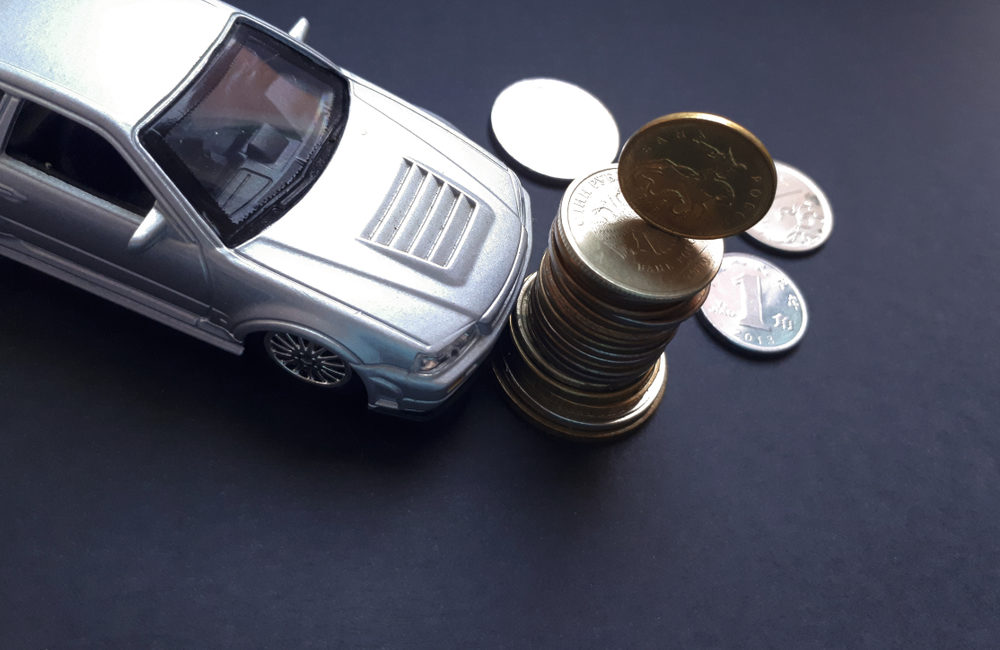 How Much Does Car Shipping Really Cost in 2025 car model and coins on a black background